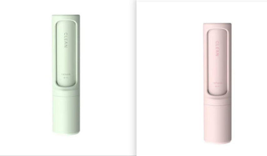 Two slim cylindrical electronic devices shown side by side on a white background, one in pale mint green and one in pale pink. Each device has a rectangular transparent window near the top showing a pink or green interior, with the word 'CLEAN' printed vertically on the front.