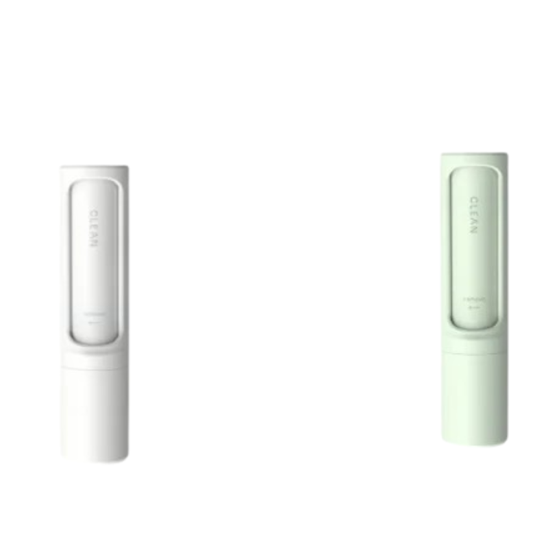 Two slim cylindrical personal care products shown side by side on a plain white background, one in white and one in pale mint green. Each has a rectangular window with the word 'CLEAN' visible on the front.