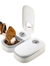 A white and gray pet double-compartment food bowl with an open lid and mirror, shown with a beagle dog eating kibble from one compartment on a white background.