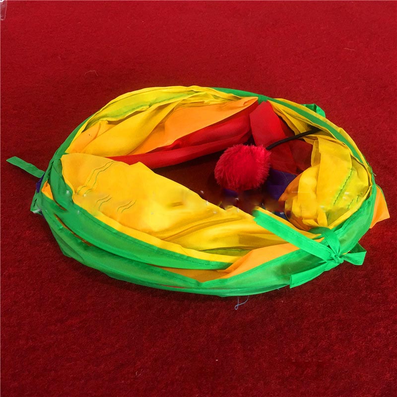 Colorful cat toy with a red ball inside on a red background