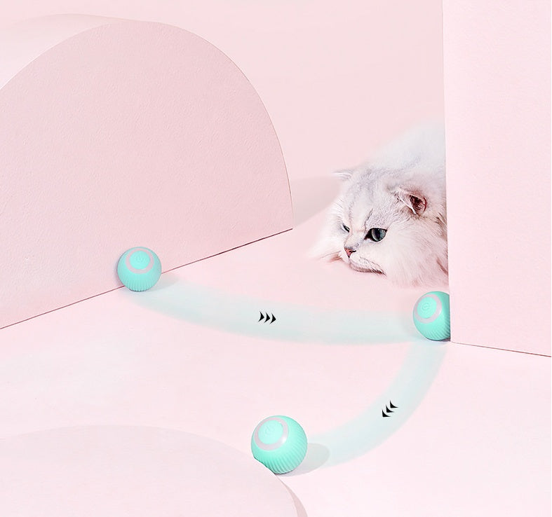 Cat toy with three green balls on a pink background