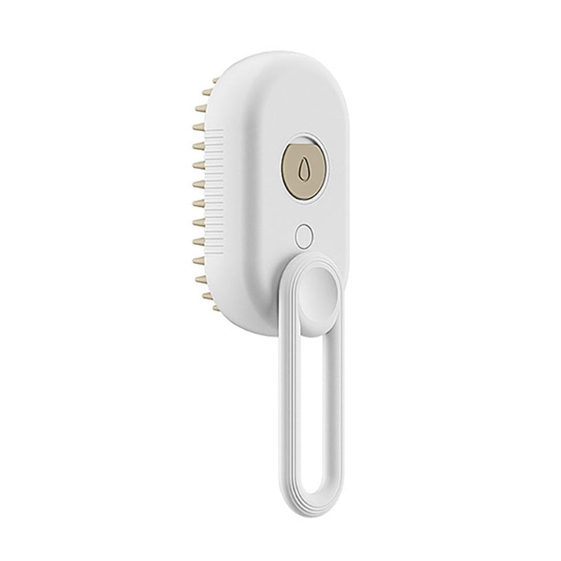 A white electric hair grooming brush with a hanging loop, featuring a circular gold power button with a water droplet icon and light gold bristles, shown against a solid white background.