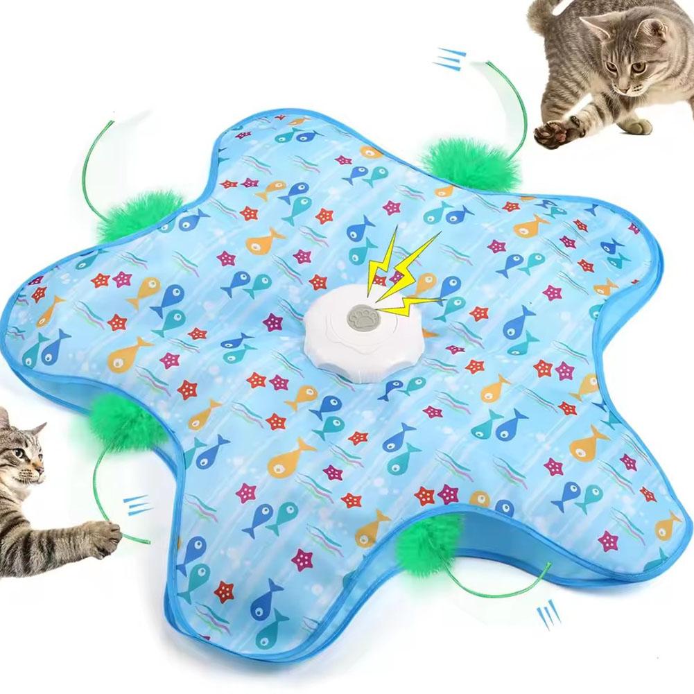 Cat toy mat with colorful designs and pom-poms, featuring two cats interacting with it.