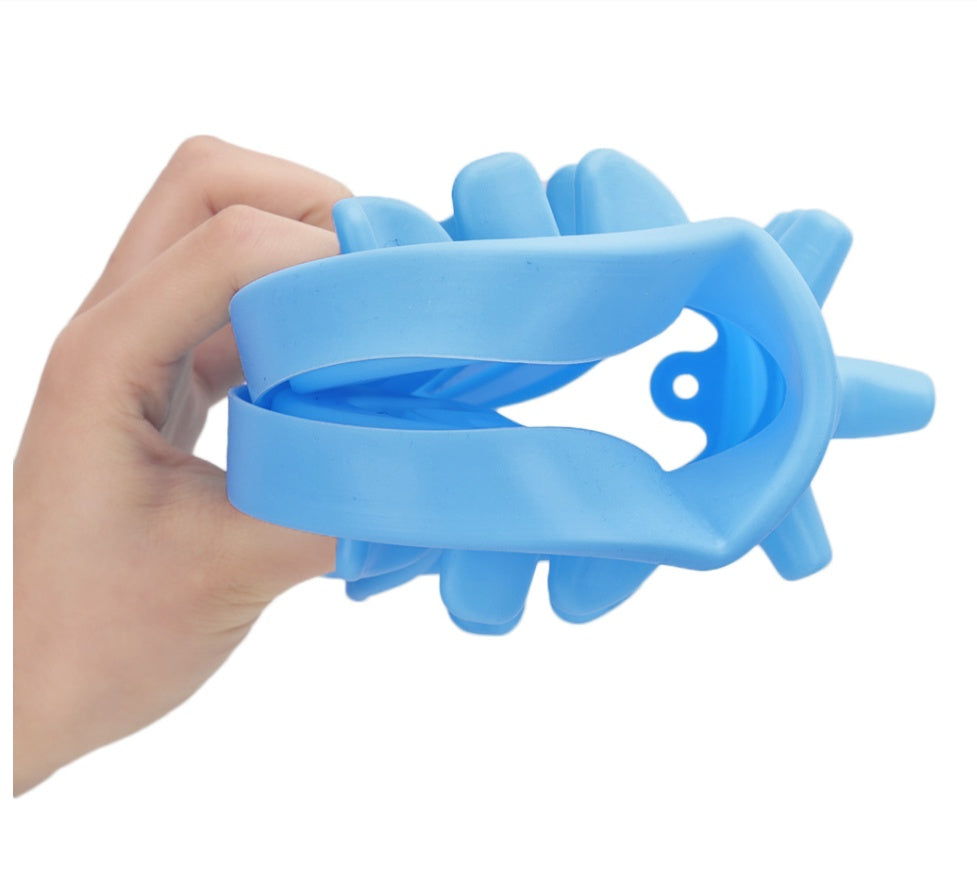 Blue silicone ring with textured design held by a hand on a white background