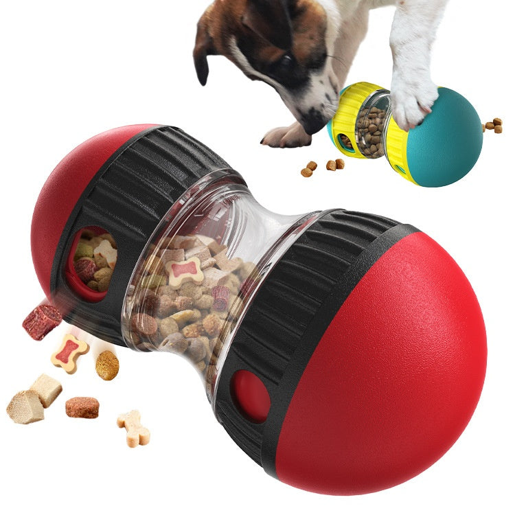 Red and black dog toy with food dispenser and a dog interacting with it.