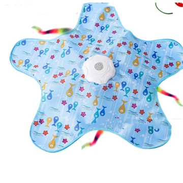 A star-shaped baby sensory pad with a light blue background, decorated with colorful cartoon fish, sea stars, and bubbles. It features a white circular suction cup in the center and multicolored elastic ties extending from the corners.