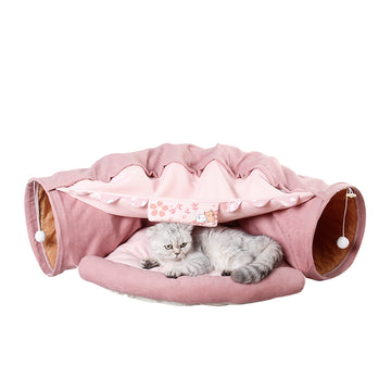 Cat lying inside a pink pet隧道 with decorative elements on a white background