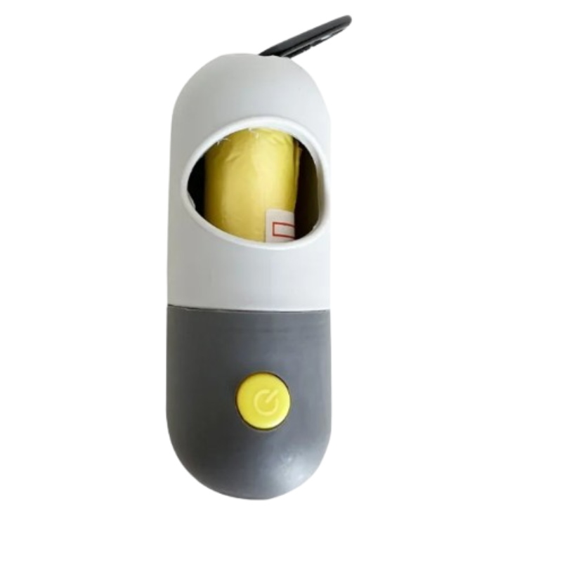 A capsule-shaped electric can opener with a white top half, dark gray bottom half, and a yellow power button. A yellow rolled item is visible inside the top opening, and a black metal loop is attached at the top.