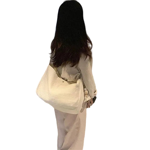 Woman walking down a hallway with a patterned carpet