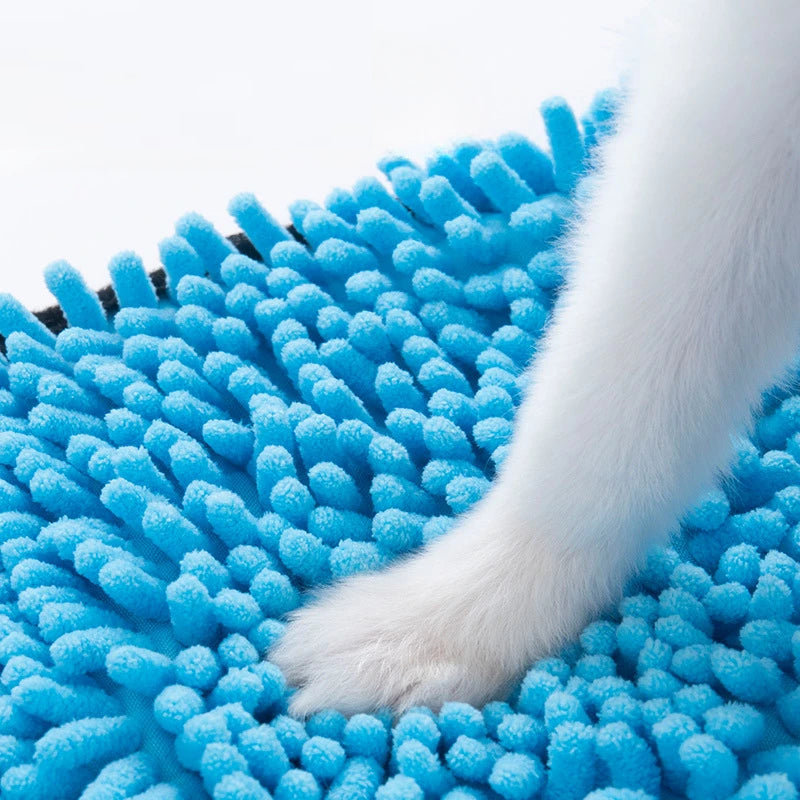 Blue grooming brush with a white paw on a white background