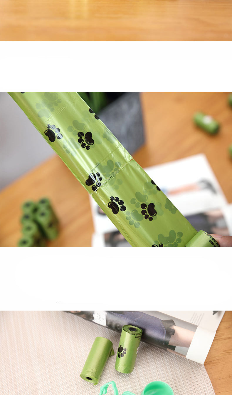 Green plastic item with black paw prints on a wooden surface