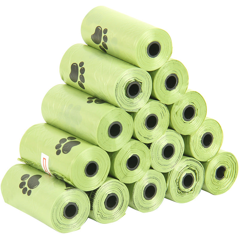 Stack of green pet waste bags with paw prints on a white background