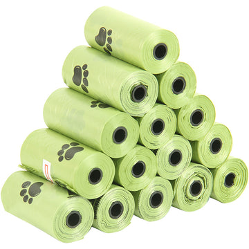 Stack of green pet waste bags with paw prints on a white background