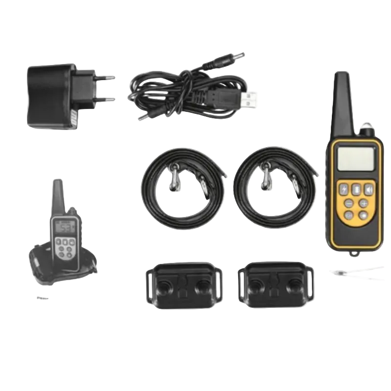 Dog training collar kit laid out on a white background, including a handheld controller with yellow trim, two black collars, two black receiver tags, a USB charging cable, a wall charger, an instruction booklet, and two small black accessories.