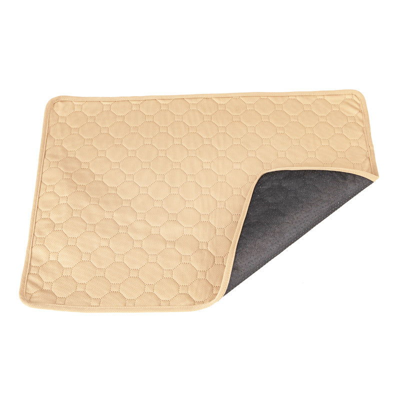 Beige quilted mat with a dark gray backing on a white background