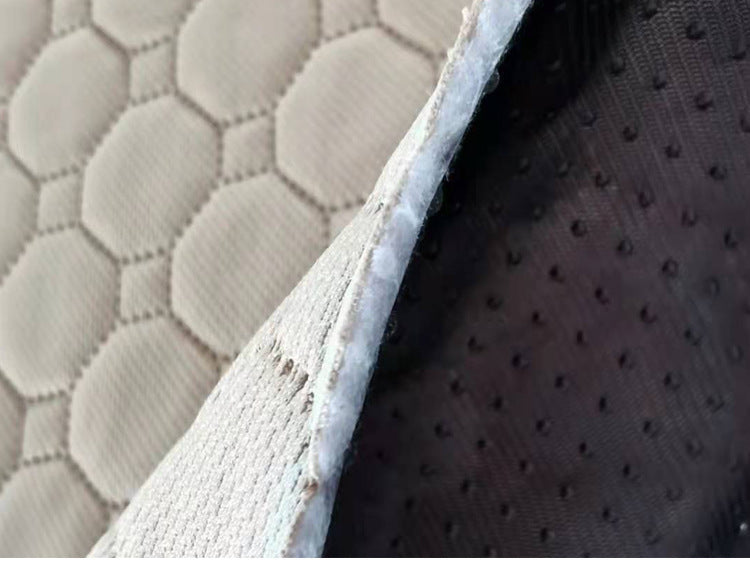 Close-up of a textured fabric surface with a honeycomb pattern.