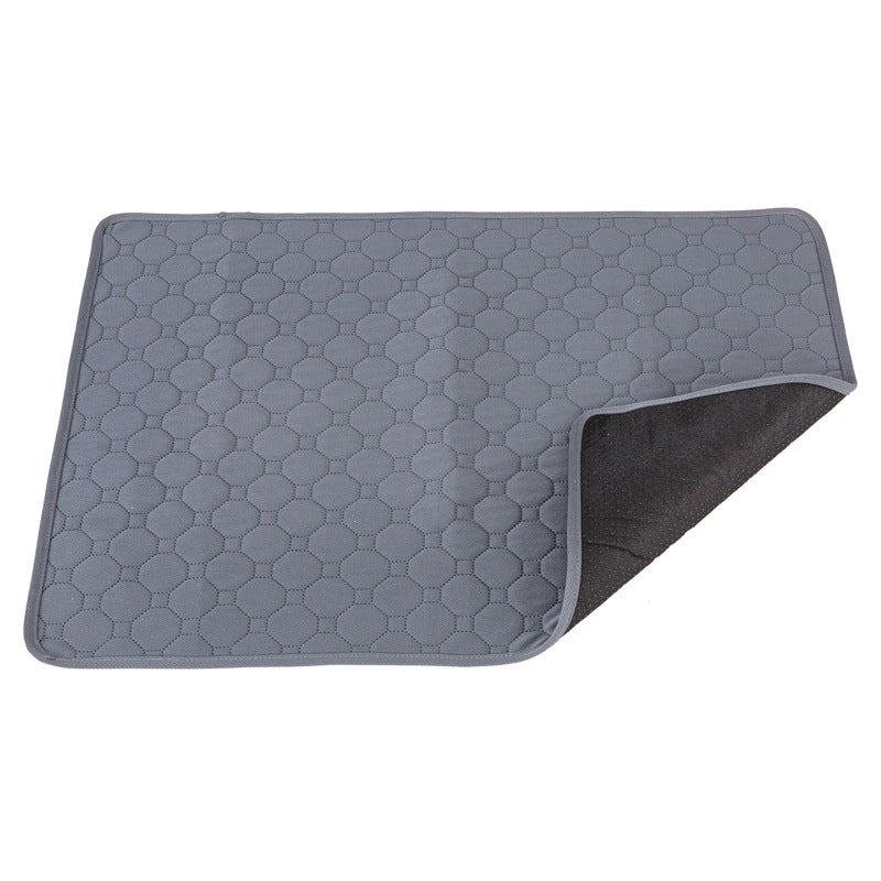 Gray quilted mat with geometric pattern on a white background